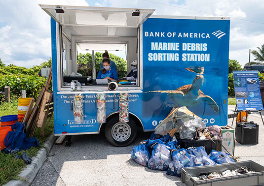 Marine Debris Sorting Station trailer with bags of collected garbage bags